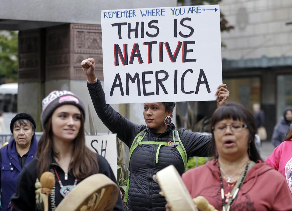 Native Americans and their allies hold a demonstration for Indigenous Peoples Day in 2015, in Seattle. <a href="https://www.youtube.com/watch?v=if-BOZgWZPE" rel="nofollow noopener" target="_blank" data-ylk="slk:AP Photo/Elaine Thompson;elm:context_link;itc:0;sec:content-canvas" class="link ">AP Photo/Elaine Thompson</a>