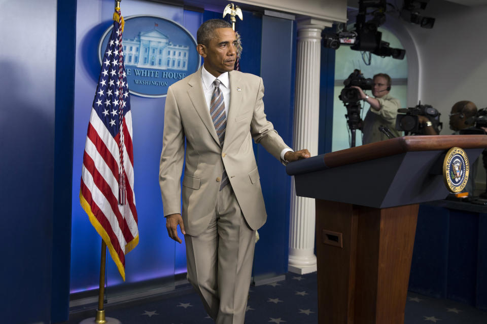 President Barack Obama leaves after speaking about the economy, Iraq, and Ukraine, Thursday, Aug. 28, 2014, in the James Brady Press Briefing Room of the White House in Washington, before convening a meeting with his national security team on the militant threat in Syria and Iraq.  (AP Photo/Evan Vucci)