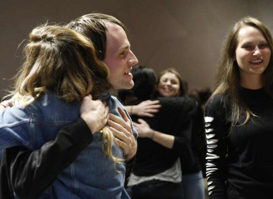 In this March 8, 2017 photo, attendees embrace during an alcohol-free social evening sponsored by The Shine at a hotel in the Williamsburg neighborhood of the Brooklyn borough of New York. Alcohol-free events, which are popping up in New York, Los Angeles and Chicago, are part of a trend fueled by millennials seeking to find meaningful connections while they party. (AP Photo/Kathy Willens)