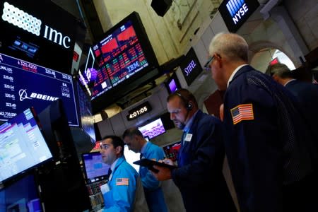 Traders work on the floor at the New York Stock Exchange (NYSE) in New York