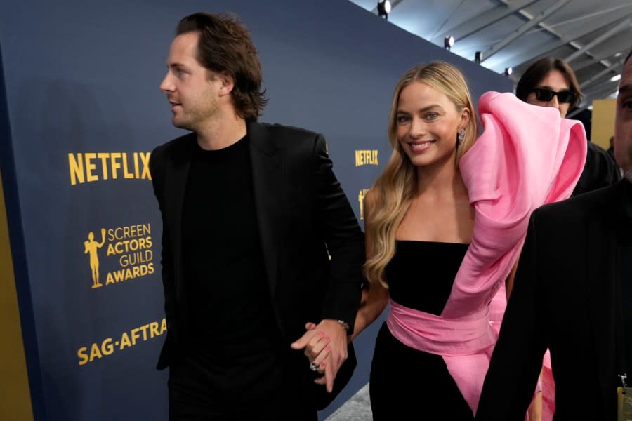 Tom Ackerley, left, and Margot Robbie arrive at the 30th annual Screen Actors Guild Awards on Saturday, Feb. 24, 2024, at the Shrine Auditorium in Los Angeles. (AP Photo/Chris Pizzello)