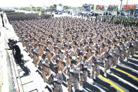 ADDS THAT ATTACK WAS ON A DIFFERENT MILITARY PARADE IN THE SOUTHWESTERN CITY OF AHVAZ - Iranian armed forces members march in a military parade marking the 38th anniversary of Iraq's 1980 invasion of Iran, in front of the shrine of the late revolutionary founder, Ayatollah Khomeini, outside Tehran, Iran, Saturday, Sept. 22, 2018. Elsewhere gunmen disguised as soldiers attacked the annual parade in the southwestern city of Ahvaz, killing dozens of people and wounding others in the bloodiest assault to strike the country in recent years. (AP Photo/Ebrahim Noroozi)