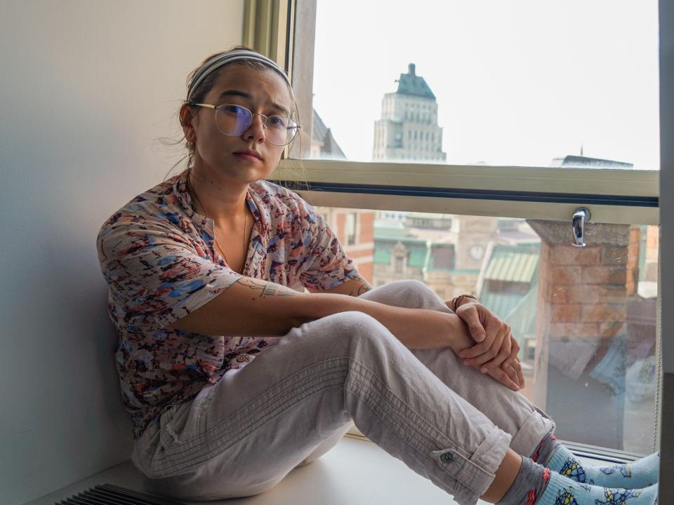 The author sits on a window sill overlooking Québec City