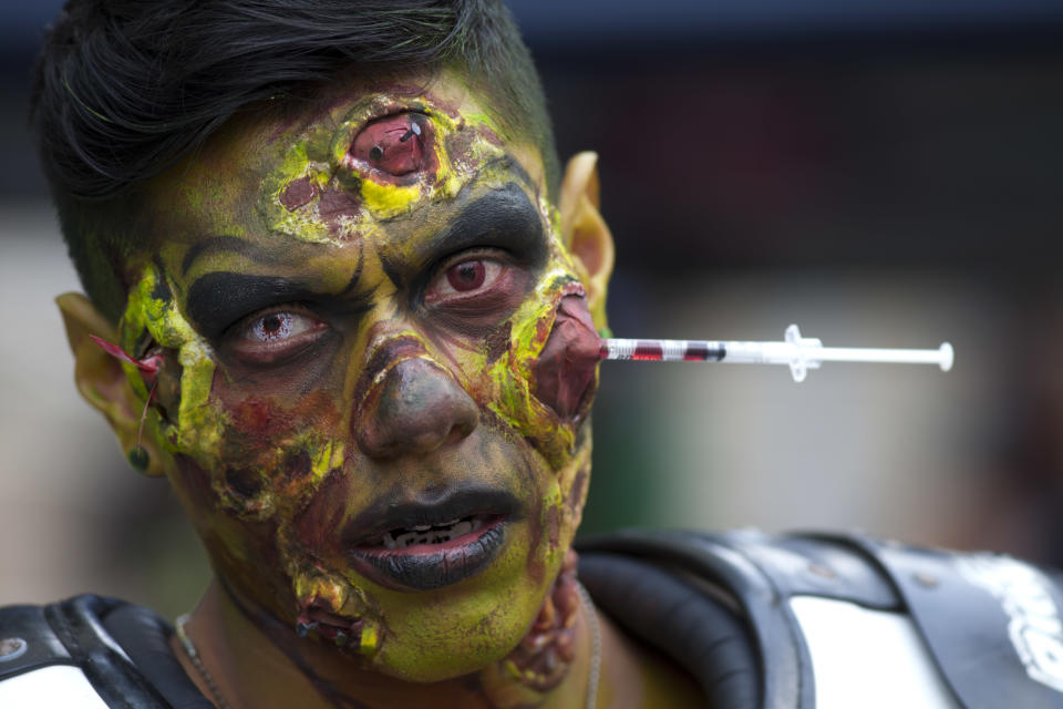 In this Nov. 11, 2018 photo, a man in makeup poses for a picture during a Zombie Walk in Mexico City. Hundreds dressed in rags and ghoulish makeup to look bloody and decaying, gathered in the historic center of Mexico's capital on Sunday afternoon to participate in the annual procession. (AP Photo/Claudio Cruz)