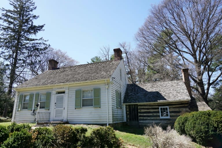 A photo taken on March 29, 2017 shows the log cabin structure which was originally used as a kitchen, next to the plantation house at Josiah Henson Park in Bethesda, Maryland