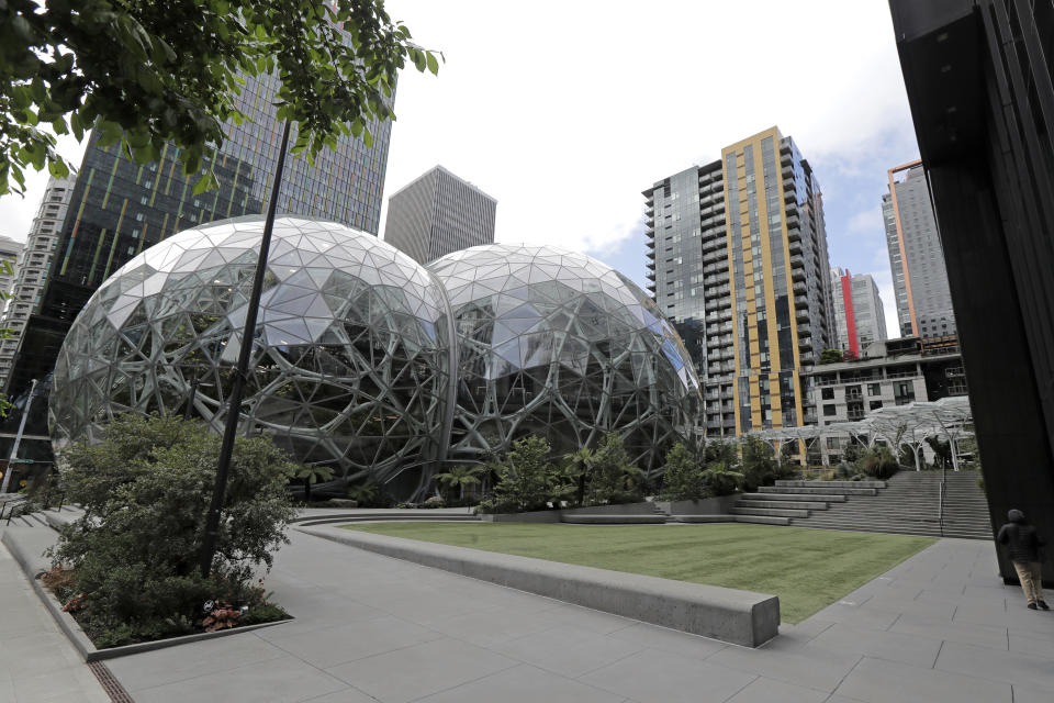 The usually busy dog walking area near the Amazon Spheres is empty of people and pets, Thursday, April 30, 2020, in downtown Seattle. Amazon.com is expected to announce earnings for the first quarter of 2020 at the close of markets Thursday, a report that is expected to be closely watched due to the effects of the coronavirus outbreak on the company. (AP Photo/Ted S. Warren)