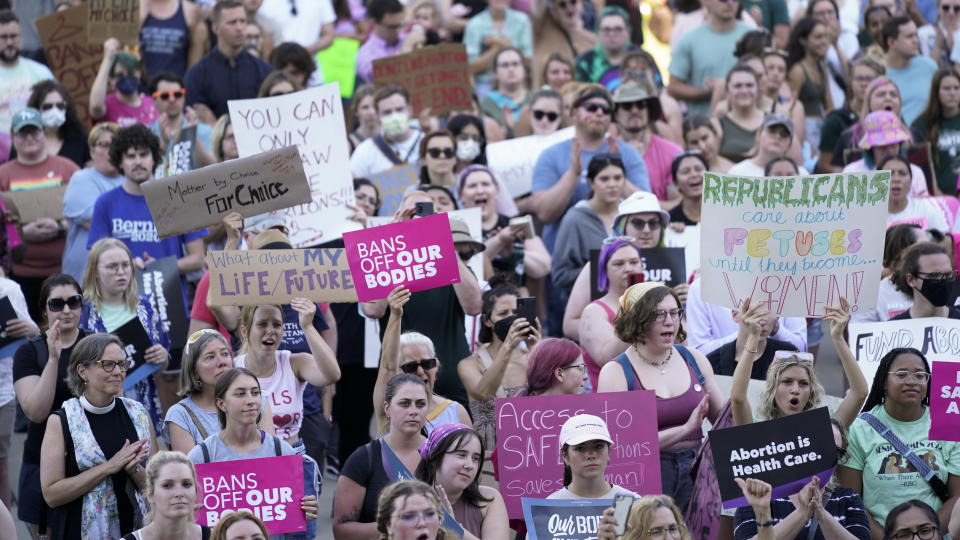 FILE - In this Friday, June 24, 2022, file photo, abortion rights protesters cheer at a rally following the United States Supreme Court's decision to overturn Roe v. Wade, federally protected right to abortion, outside the state capitol in Lansing, Mich. The Michigan Court of Appeals ruled Monday, Aug. 1, 2022, that county prosecutors can enforce the state's 91-year-old abortion ban, paving the way for abortion to become illegal in parts of the state. (AP Photo/Paul Sancya, File)