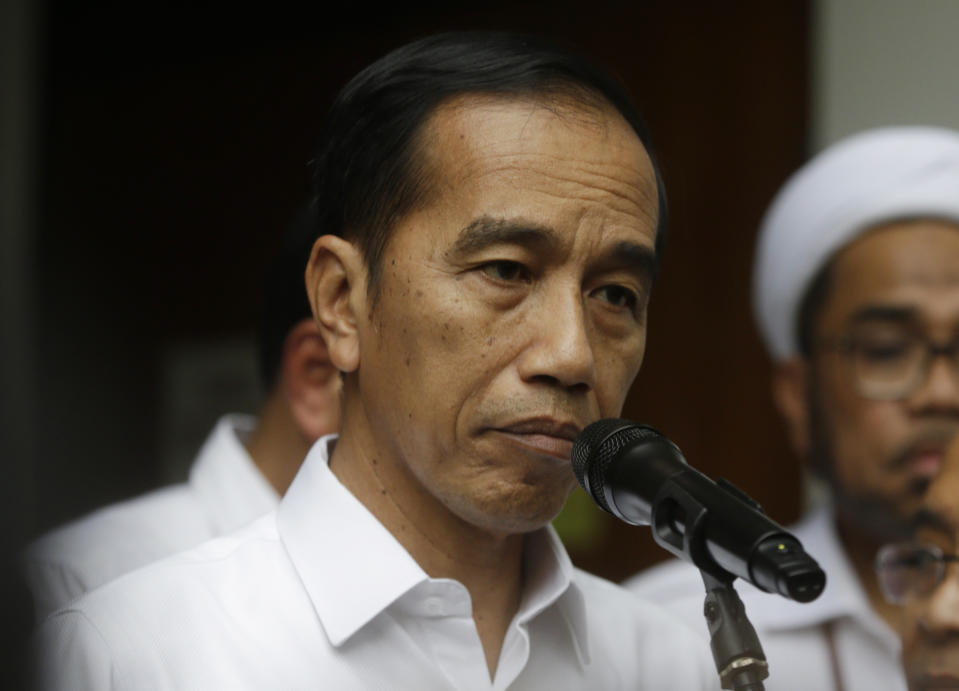 Indonesian President Joko Widodo speaks to journalists after visiting Coordinating Minister for Politics, Law and Security Wiranto who was wounded in a knife attack, at a hospital in Jakarta, Indonesia, Thursday, Oct. 10, 2019. A knife-wielding man, who may have been radicalized by the Islamic State group's extremist ideology, wounded the top security minister, a local police chief and another person in a western province on Thursday, police said. (AP Photo/Achmad Ibrahim)