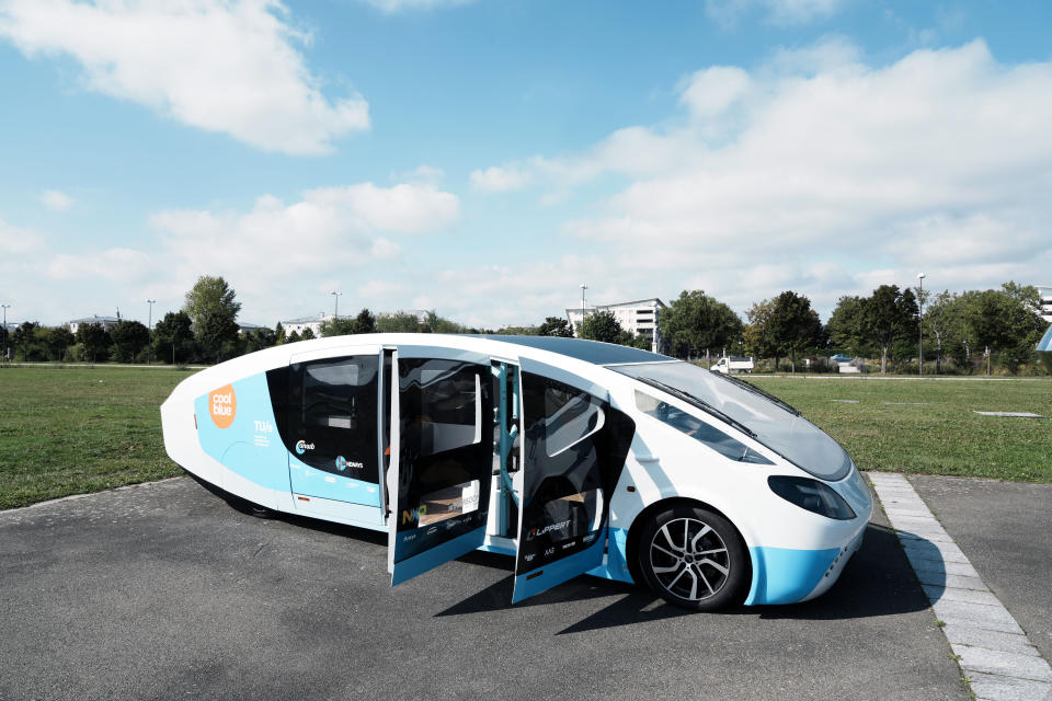 The solar-powered vehicle is on display on a closed road, in Guyancourt, south of Paris, Friday Sept. 24, 2021. A group of Dutch students has reimagined van life and is hitting the road to Portugal. Just don't call their groundbreaking new solar-powered vehicle a campervan. (AP Photo/Thibault Camus)