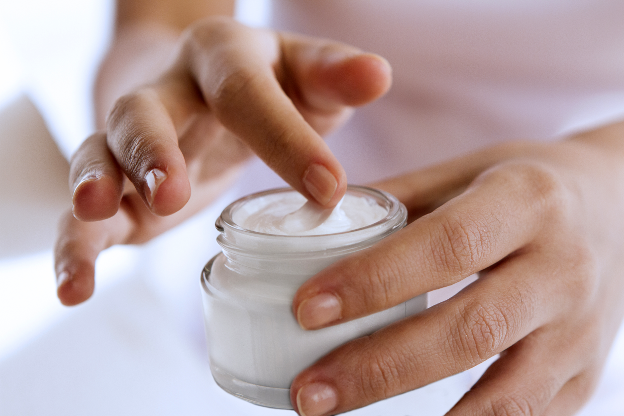 woman using facial cream