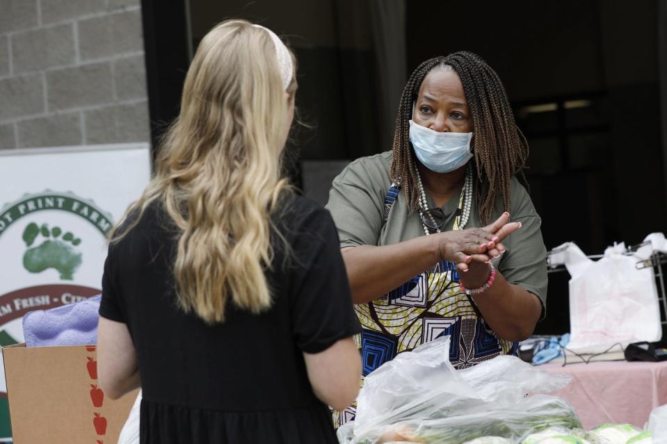 <span class="caption">Farm owner Cindy Ayers Elliott talks with a customer about ways to clean and prepare fresh vegetables at a farmers market in Jackson, Mississippi.</span> <span class="attribution"><a class="link " href="http://apimages.com" rel="nofollow noopener" target="_blank" data-ylk="slk:AP Photo/Rogelio V. Solis;elm:context_link;itc:0;sec:content-canvas">AP Photo/Rogelio V. Solis</a></span>