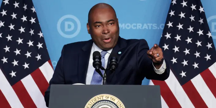 DNC Chairman Jaime Harrison points from the podium as he addresses Democratic Party members at a winter meeting.