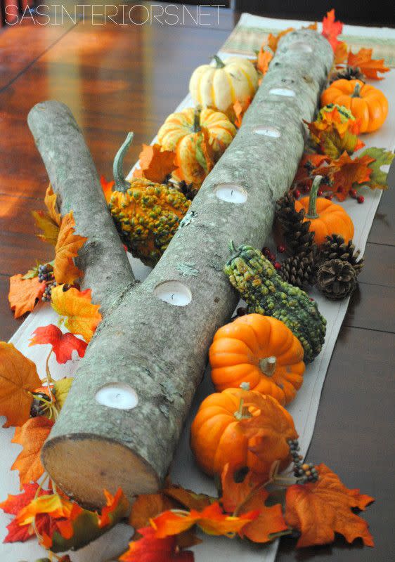 <p>Decorate a log from your backyard with gourds and fall leaves for a rustic masterpiece. Make it even dreamier by drilling holes into the log, and submerging votive candles down the middle.</p><p><strong>Get the tutorial at <a rel="nofollow noopener" href="http://www.jennaburger.com/2011/10/5-minute-autumn-centerpiece/" target="_blank" data-ylk="slk:SAS Interiors;elm:context_link;itc:0;sec:content-canvas" class="link ">SAS Interiors</a>. </strong></p>