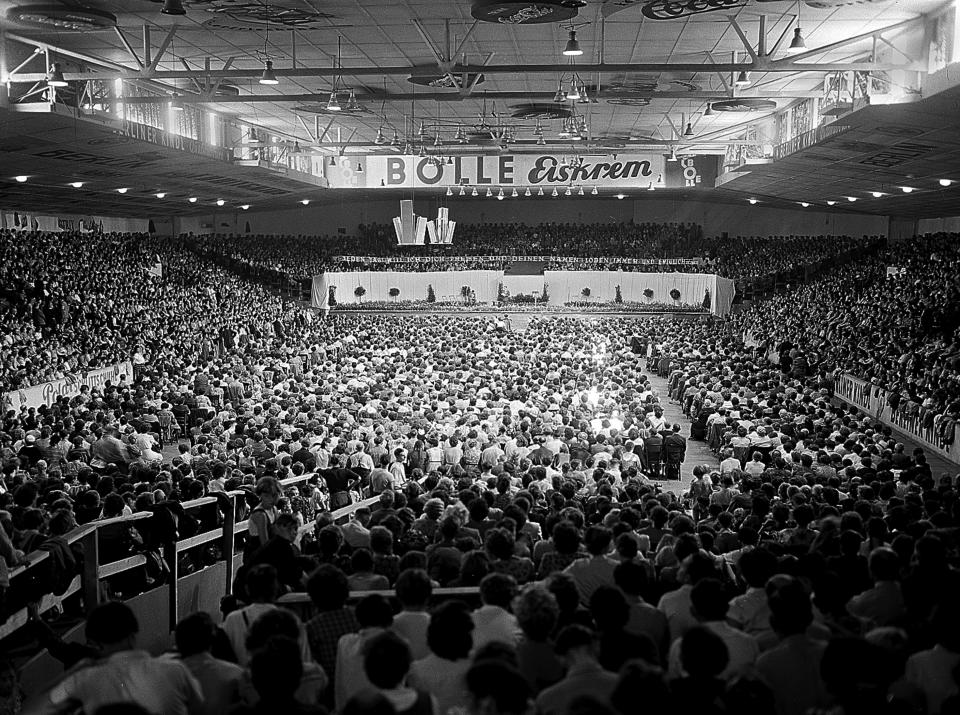 FILE - This general view shows Jehovah's Witnesses gathered for their annual convention at West Berlin's Sportpalast Hall, Germany, on Aug. 5, 1954. Several people were killed and injured late Thursday, March 9, 2023, after shots were fired inside a building where Jehovah’s Witnesses met in the northern German city of Hamburg, officials said. The international Christian denomination founded in the United States has a more than 100-year history in Germany. (AP Photo/Heinrich Sanden Jr., File)