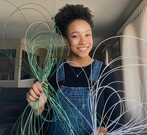 Sophia Lacroix holds some of the 3D printer filament made by the PETBOT machine. 