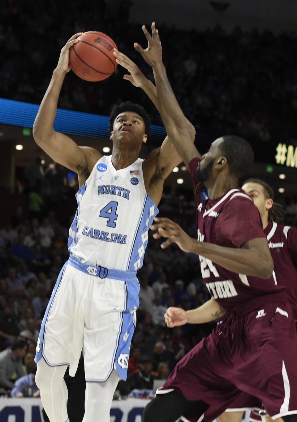 North Carolina's Isaiah Hicks (4) shoots over Texas Southern's Marvin Jones (24) during the first half in a first-round game of the NCAA men's college basketball tournament in Greenville, S.C., Friday, March 17, 2017. (AP Photo/Rainier Ehrhardt)