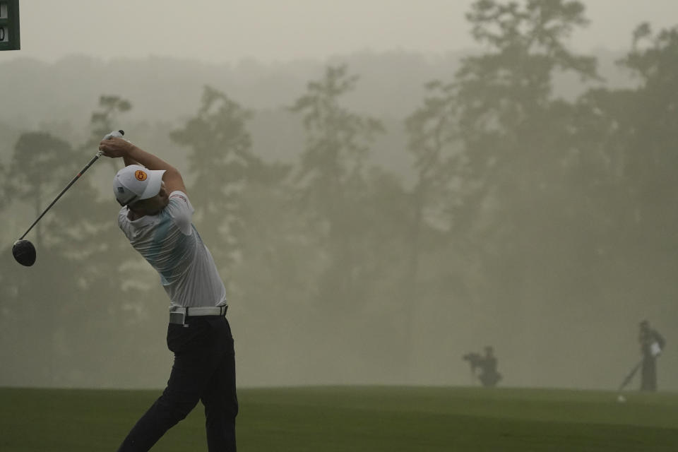 Jazz Janewattananond, of Thailand, tees off on the first hole during the first round of the Masters golf tournament Thursday, Nov. 12, 2020, in Augusta, Ga. (AP Photo/Charlie Riedel)