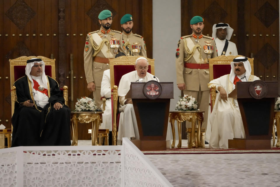 Pope Francis, flanked by Bahrain's King Hamad bin Isa Al Khalifa, right, and Bahrain's Prince Salman bin Hamad Al Khalifa, left, delivers his speech during their meeting at the Sakhir Royal Palace, Bahrain, Thursday, Nov. 3, 2022. Pope Francis is making the November 3-6 visit to participate in a government-sponsored conference on East-West dialogue and to minister to Bahrain's tiny Catholic community, part of his effort to pursue dialogue with the Muslim world. (AP Photo/Hussein Malla)