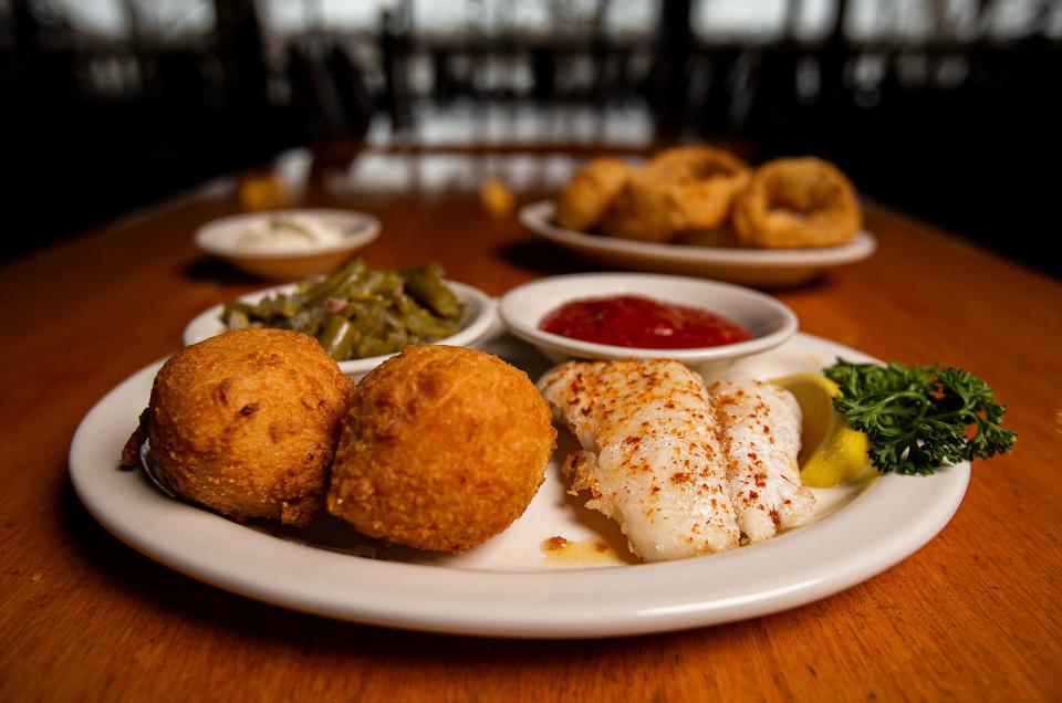 The broiled whitefish platter with green beans, hush puppies and onion rings is served at the KingFish location on River Rd. in Louisville, Ky. Feb. 14, 2023