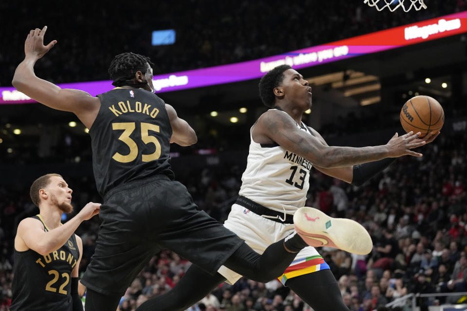 Toronto Raptors center Christian Koloko (35) looks on as Minnesota Timberwolves forward Nathan Knight (13) goes for the basket during the second half of an NBA basketball game, in Toronto, Saturday, March 18, 2023. (Frank Gunn/The Canadian Press via AP)