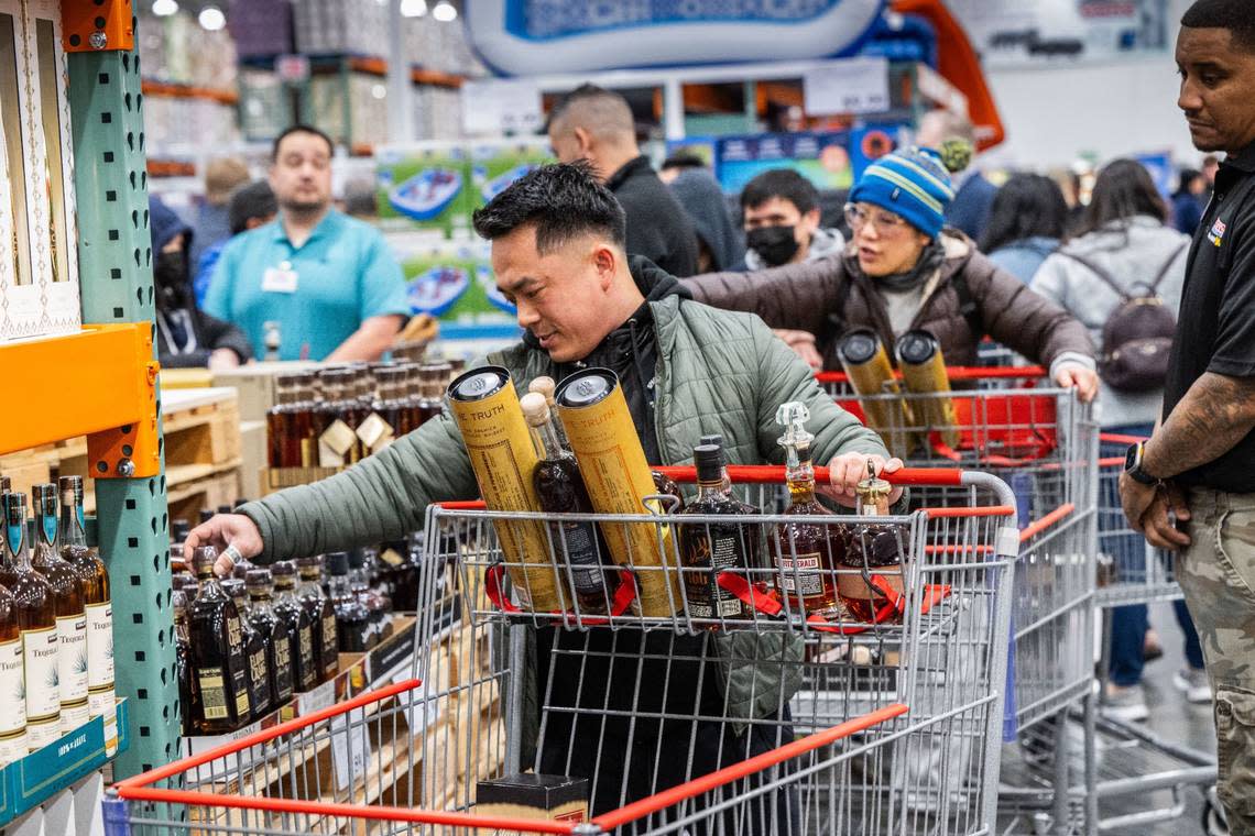 Barry Thepvong, of Fresno, looks at whisky bottles during the grand opening of the Natomas Costco store on Thursday, March 14, 2024. Thepvong said he made the trip last night in hopes of buying liquor at specially discounted prices for the grand opening.