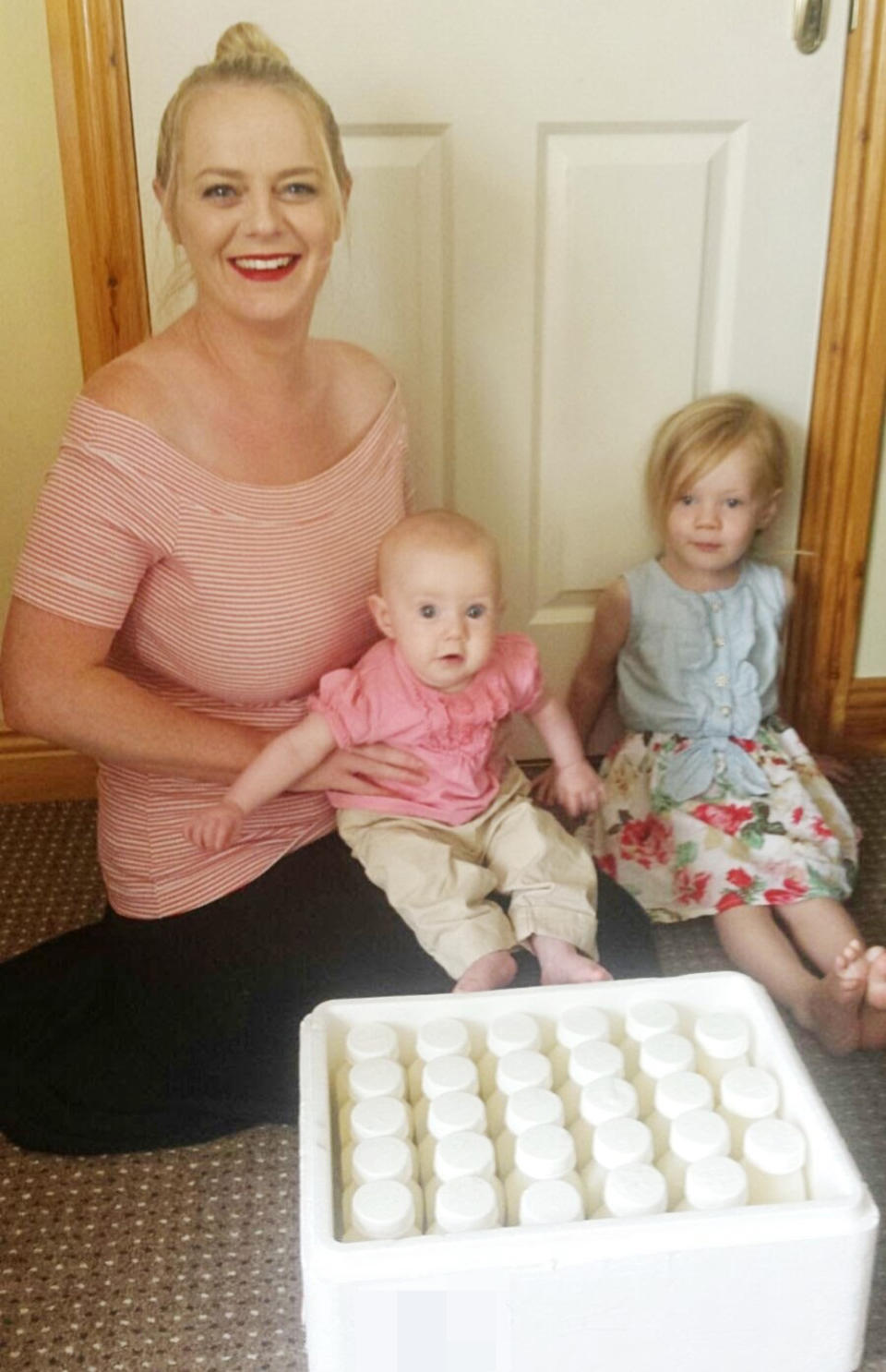 Natasha, pictured here with her daughters Grace and Ellie, and the milk she donated (PA Real Life/Collect)