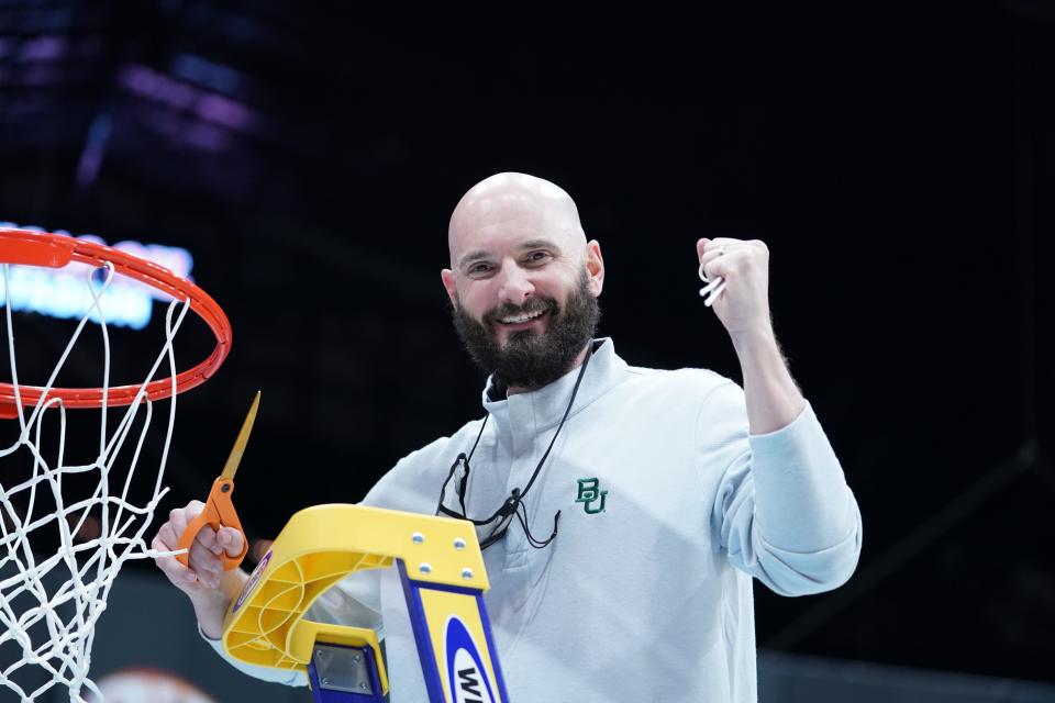 John Jakus takes his turn cutting down the net after Baylor won the national championship in 2021.