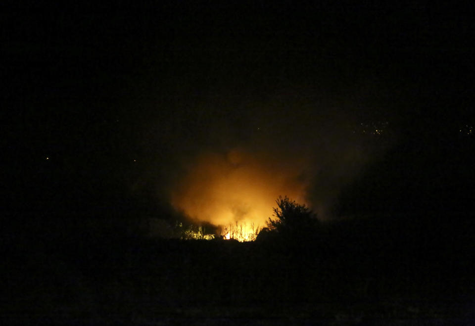 Flames are seen at the site of a plane crash, a few miles away from the city of Kavala, in northern Greece, Saturday, July 16, 2022. An Antonov cargo plane operated by a Ukraine-based air carrier crashed Saturday near the city of Kavala in northern Greece, authorities said. Greek Civil Aviation authorities say the flight was heading from Serbia to Jordan, but have not been able to confirm how many people were on board or what the plane's cargo was. (Ilias Kotsireas/InTime News via AP)