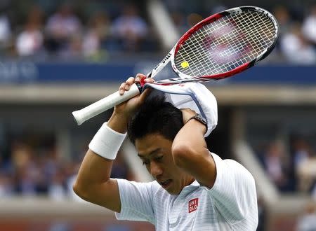 Kei Nishikori of Japan adjusts his cap during the men's singles final match against Marin Cilic of Croatia at the 2014 U.S. Open tennis tournament in New York, September 8, 2014. REUTERS/Adam Hunger