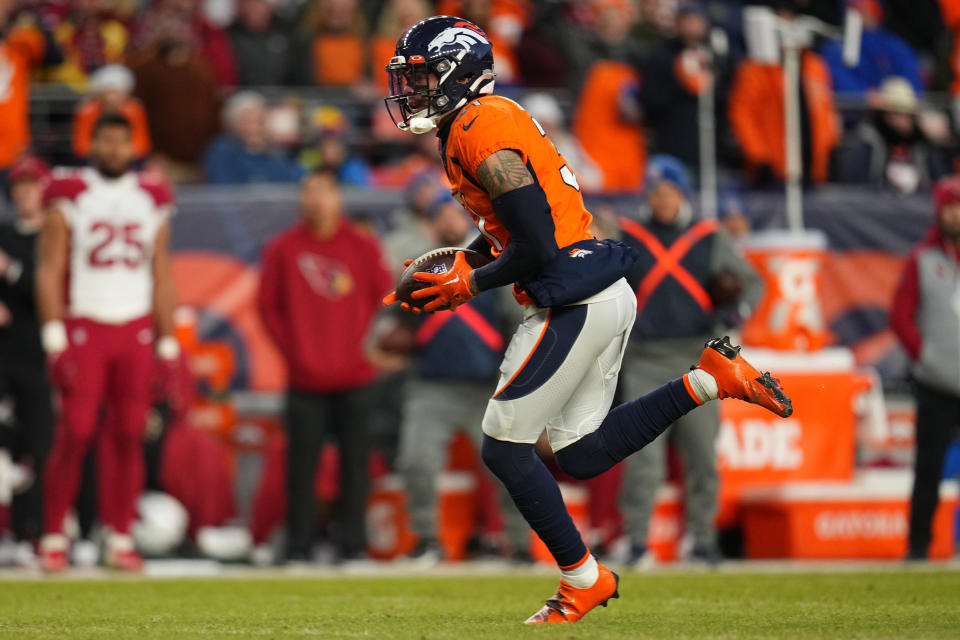 Denver Broncos safety Justin Simmons (31) runs back an interception against the Arizona Cardinals during the second half of an NFL football game, Sunday, Dec. 18, 2022, in Denver. (AP Photo/Jack Dempsey)