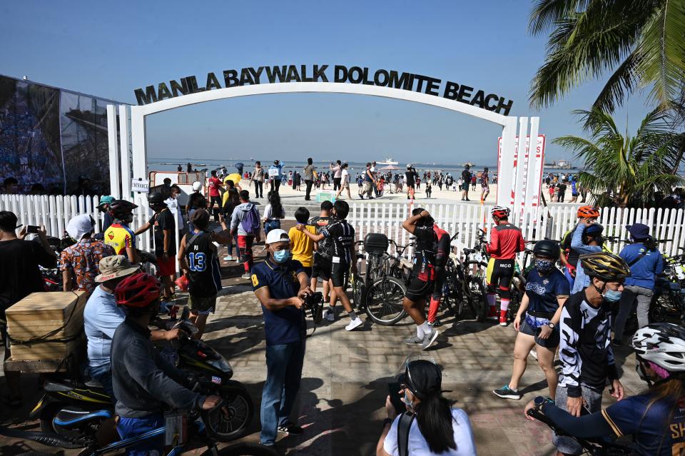 People trooping to the Manila baywalk dolomite beach along Roxas boulevard in Manila, Philippines on October 17, 2021, a day after authorities eased its quarantine restrictions in the nation's capital. (Photo: TED ALJIBE/AFP via Getty Images)