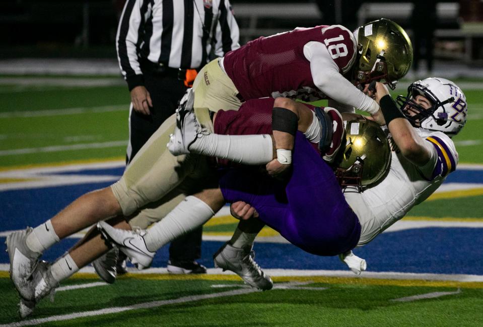 Watterson defenders take down Bloom-Carroll quarterback Ethan Thanthanavong during Friday's regional semifinal.