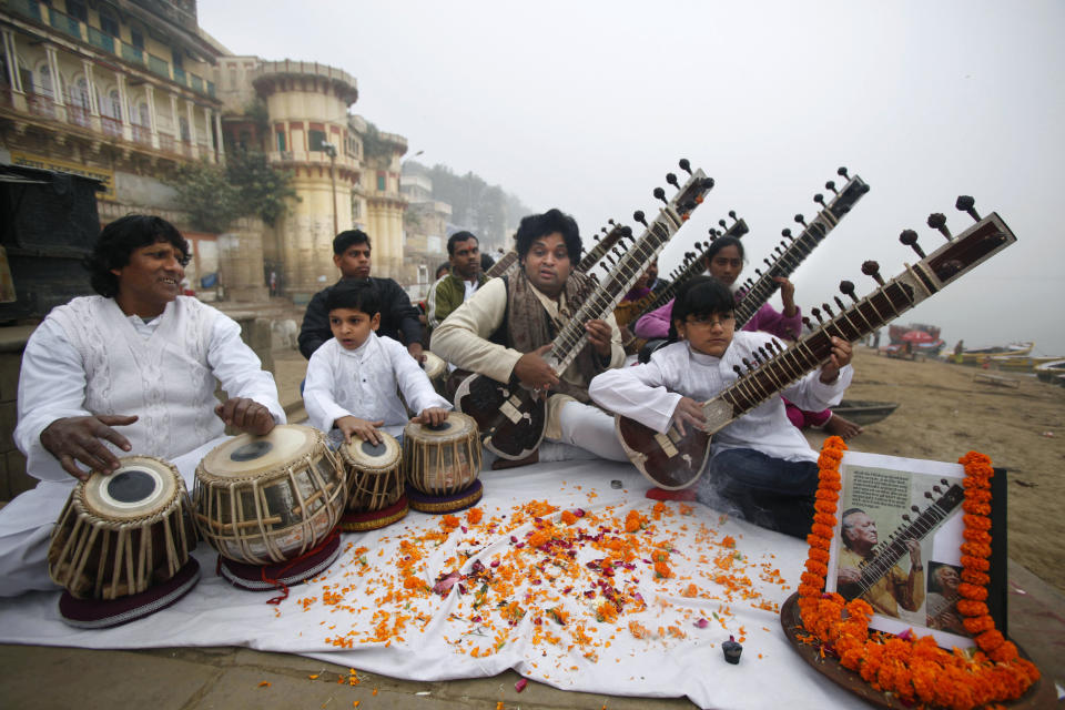 Members of Vande Mataram music society play sitars during a function to offer tributes to legendary Indian sitar player Ravi Shankar on the banks of the Ganges River in Varanas , India, Thursday, Dec. 13, 2012. Shankar, who is credited with connecting the world to Indian music, died Tuesday in San Diego at the age of 92. (AP Photo/Rajesh Kumar Singh)