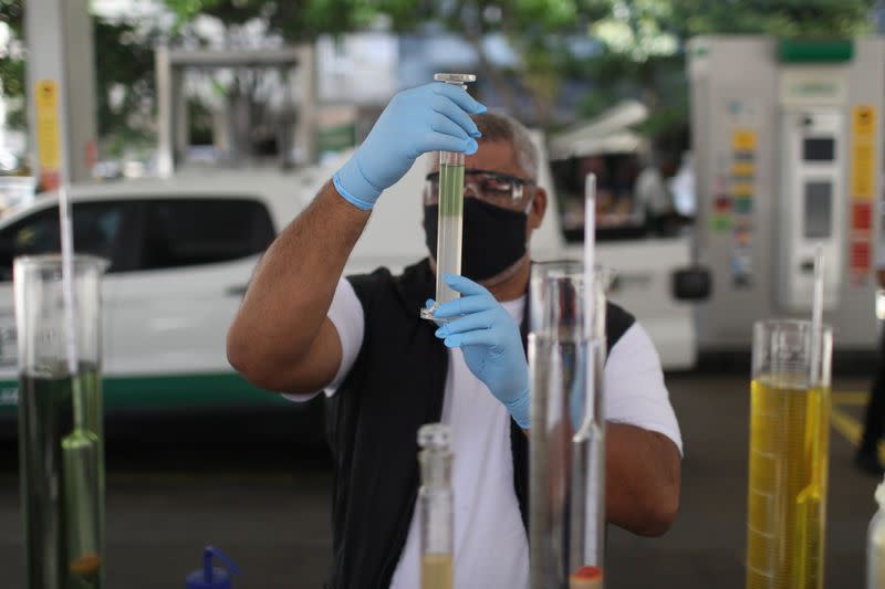 A worker of National Petroleum Agency ANP, makes a procedure to check fuel quality at a gas station in Rio de Janeiro