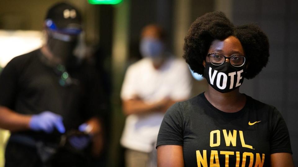 Ashley Nealy waits in line at State Farm Arena, Georgia’s largest early voting location, to cast her ballot during the first day of early voting in the general election on October 12, 2020 in Atlanta, Georgia. (Photo by Jessica McGowan/Getty Images)