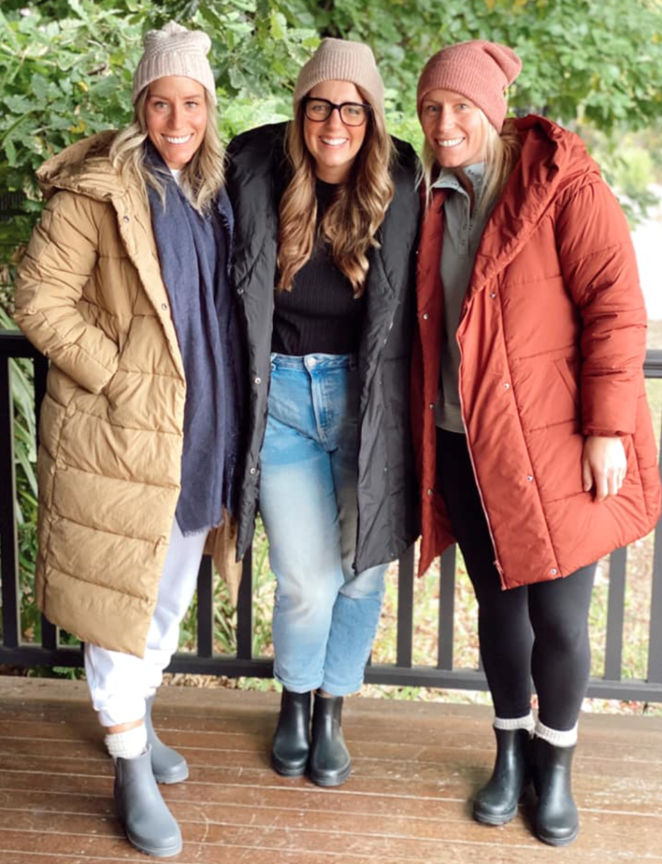 three women wearing kmart longline puffer jackets 