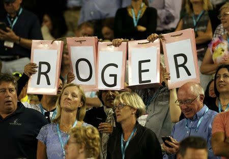 Supporters of Switzerland's Roger Federer hold a sign during his semi-final match against Serbia's Novak Djokovic at the Australian Open tennis tournament at Melbourne Park, Australia, January 28, 2016. REUTERS/Issei Kato