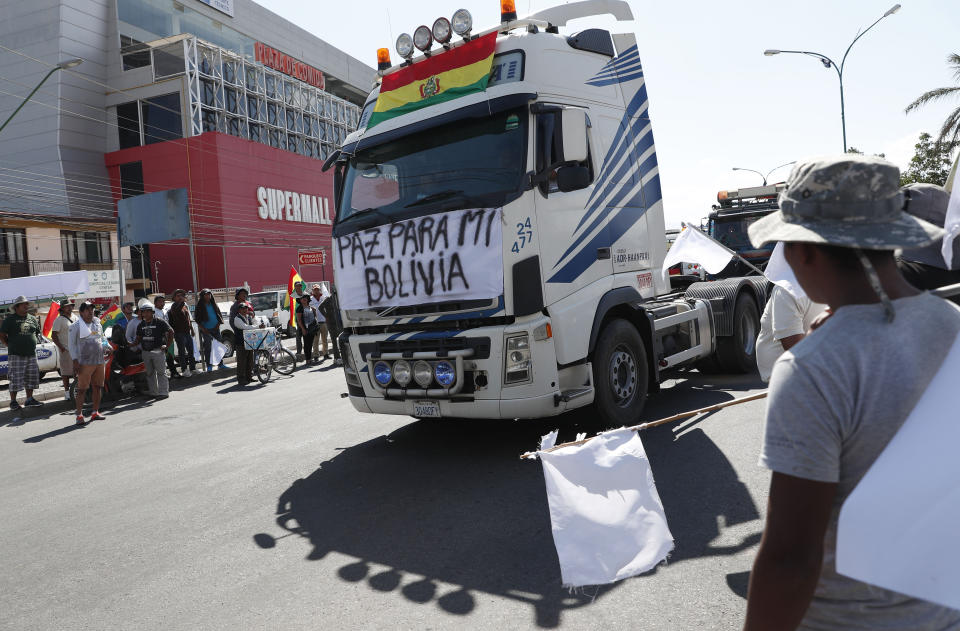 A truck passes with a sign reading in Spanish "Peace for my Bolivia" during a truck drivers protest asking for peace and roads without blockages in Cochabamba, Bolivia, Wednesday, Nov. 20, 2019. Bolivia has been in a state of turbulence since a disputed Oct. 20 vote. Former President Evo Morales resigned Nov. 10, but his supporters oppose the interim government that took his place. (AP Photo/Juan Karita)