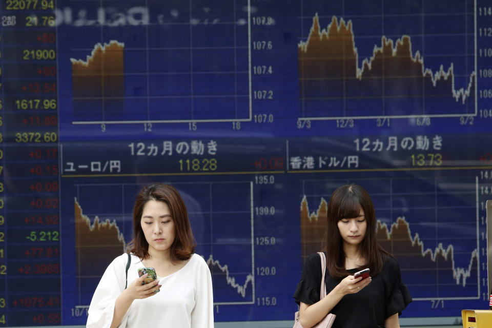 People stand in front of an electronic stock board of a securities firm in Tokyo, Tuesday, Sept. 24, 2019. Shares have edged higher in Asia as U.S. Treasury Secretary Steven Mnuchin confirmed that China-U.S. trade talks were due to resume in two weeks’ time. The Shanghai Composite index rose 0.8% and shares also rose in Tokyo and Hong Kong. (AP Photo/Koji Sasahara)