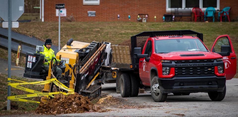 Construction crews dig holes for a fiber cable along Glenwood Avenue on Monday, Dec. 5, 2022.