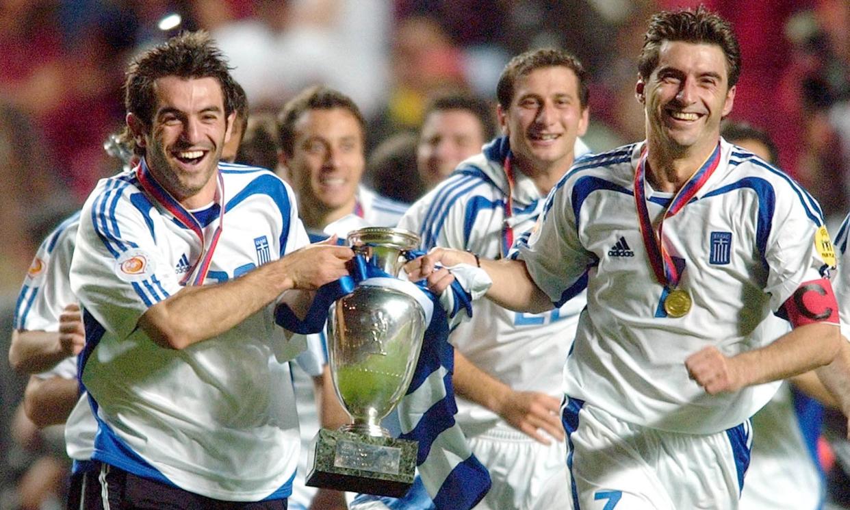 <span>Georgios Karagounis (left) and Theodoros Zagorakis with the European Championship trophy after they beat Portugal in the 2004 final.</span><span>Photograph: Dušan Vranić/AP</span>