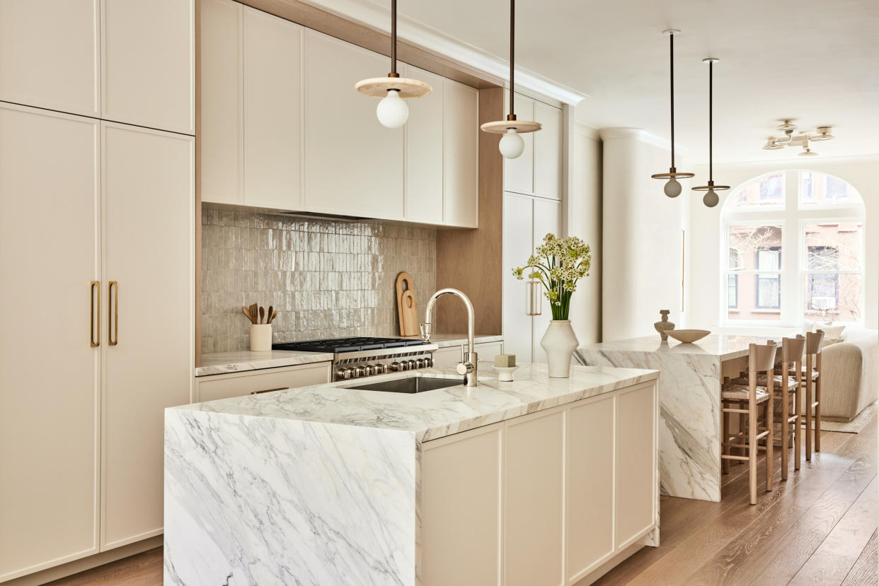  White kitchen cabinets with zellige tiles. 