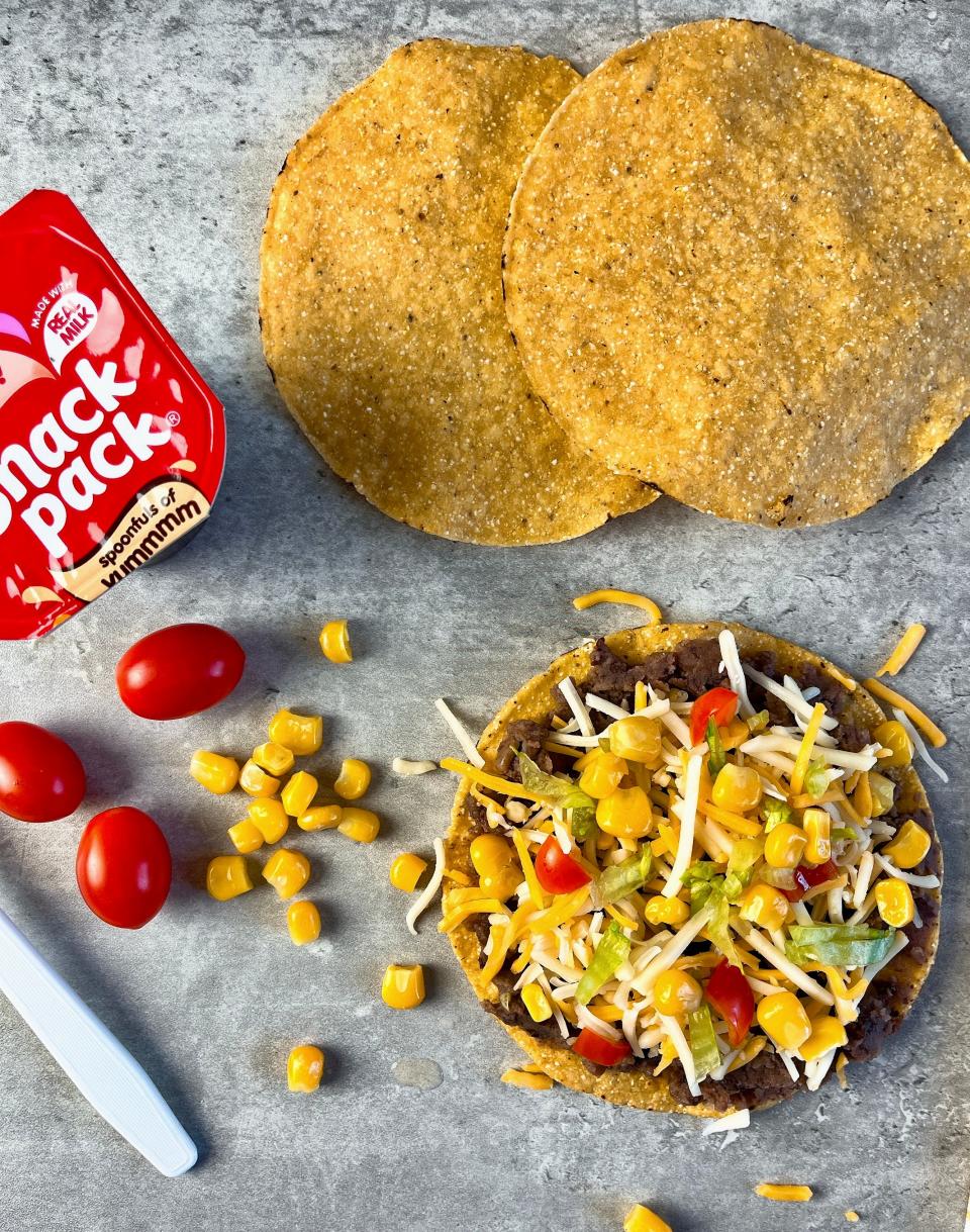 Top whole grain tostada shells with refried beans, shredded Mexican cheese or cheddar cheese, shredded lettuce, diced tomatoes, and corn. Note: If desired, pack each item separately so your child can assemble the tostadas at school.