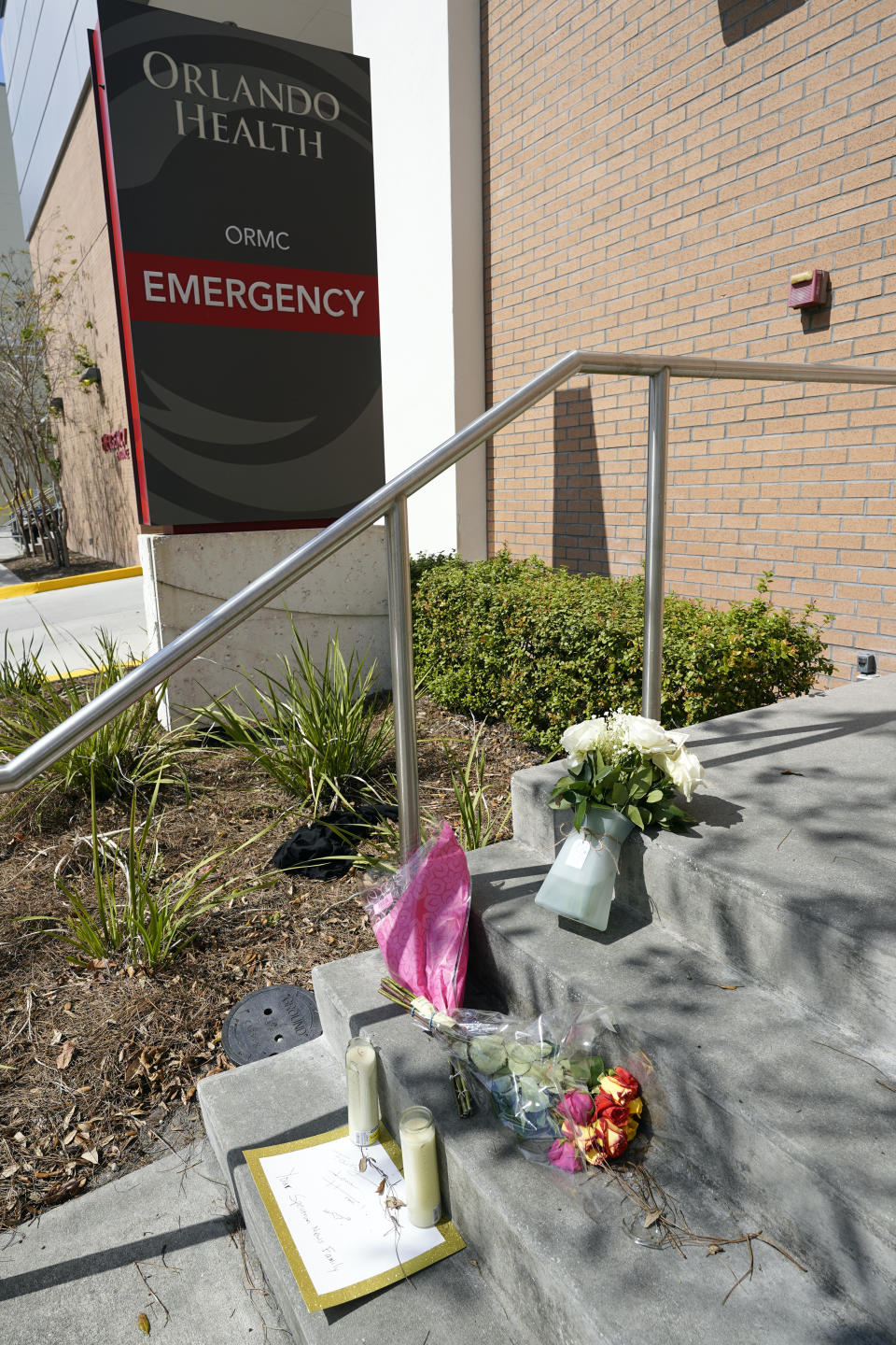 Flowers and notes were left at a small makeshift memorial in front of the emergency room at Orlando Regional Medical Center Thursday, Feb. 23, 2023, in Orlando, Fla. A TV journalist and a child were shot and killed yesterday and several others were injured at a scene where a woman was found murdered earlier in the day. (AP Photo/John Raoux)