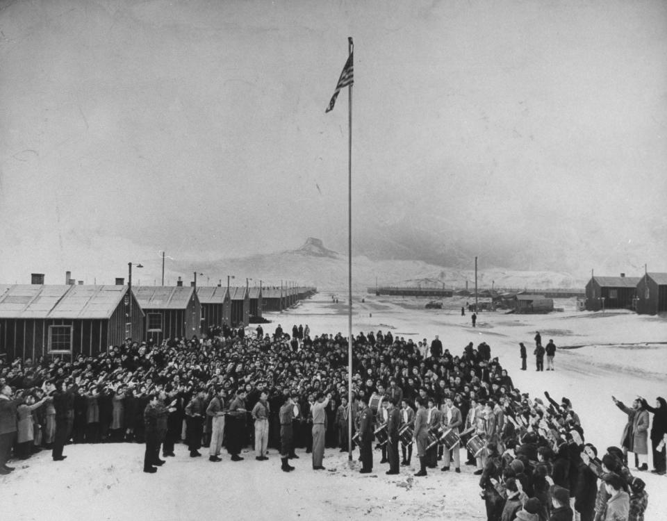 Nisei Japanese-Americans participating in a flag saluting ceremony at a relocation center in forced internment during WWII, 1942.<span class="copyright">Hansel Mieth—The LIFE Picture Collection/Getty Images</span>