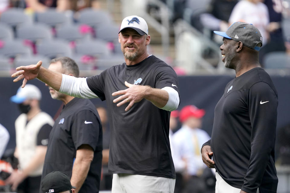 Detroit Lions head coach Dan Campbell, left, talks with Offensive Coordinator Anthony Lynn before an NFL football game against the Chicago Bears Sunday, Oct. 3, 2021, in Chicago. (AP Photo/David Banks)