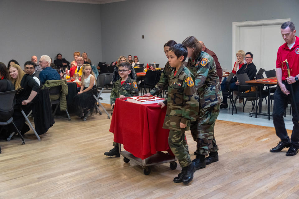 The Bomb City young Marines bring out the birthday cake Friday night at the Marine Corps birthday event in Amarillo.