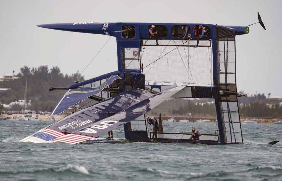 In this photo provided by SailGP, the USA SailGP Team, helmed by Jimmy Spithill, is capsized during the first race on race Day 2 of the Bermuda SailGP event in Hamilton, Bermuda, Sunday, April 25, 2021. (Bob Martin/SailGP via AP)