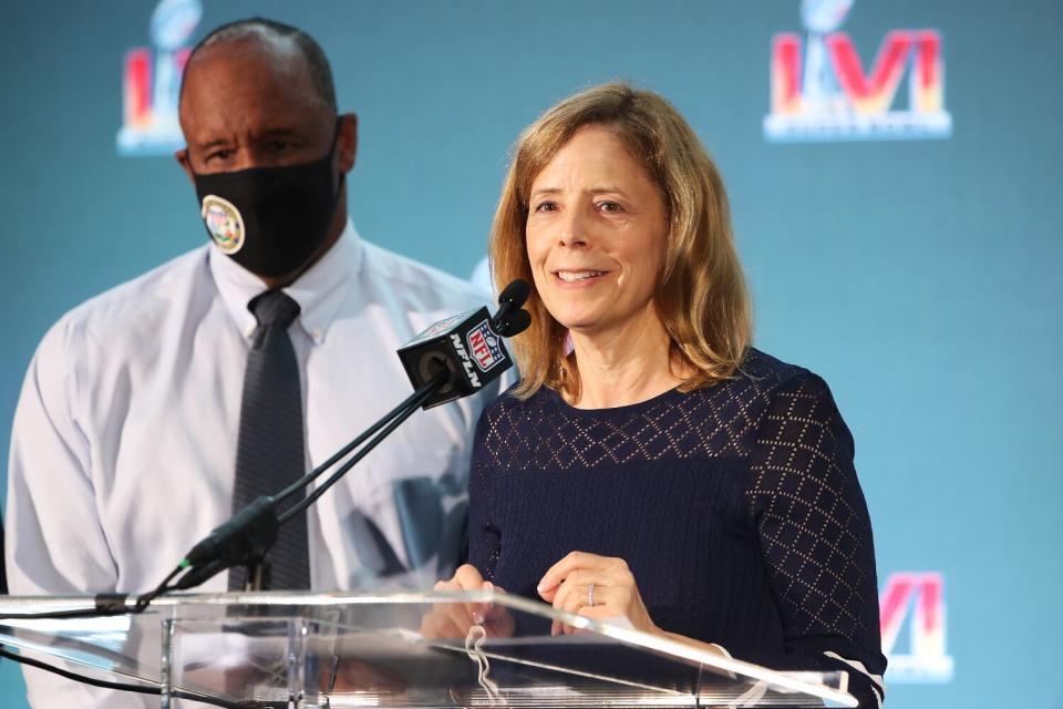 A man and a woman stand at a lectern.