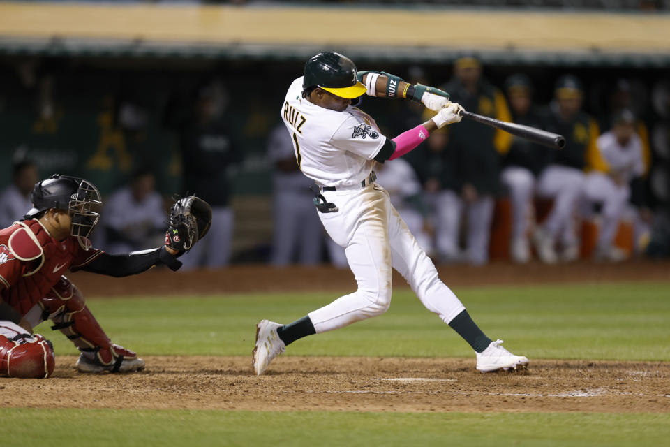 Oakland Athletics center fielder Esteury Ruiz, right, hits a game winning single in front of Arizona Diamondbacks catcher Gabriel Moreno, left, during the 12th inning of a baseball game in Oakland, Calif., Tuesday, May 16, 2023. (AP Photo/Jed Jacobsohn)